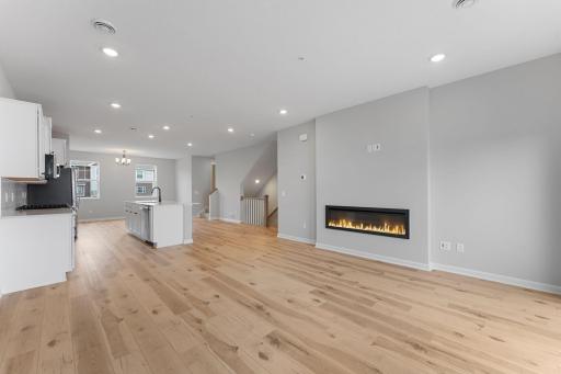 Anchored by a modern electric fireplace and accented by the warmth of the floors, high ceilings, and large windows, the family room is a great place to gather! Similar home shown, Color and options can vary.