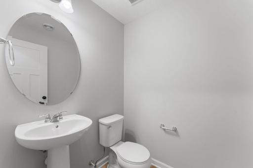 Convenient powder room bathroom. Similar home shown, Color and options can vary.