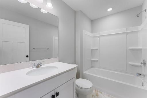 Main bathroom is located steps away from the secondary bedrooms. Similar home shown, Color and options can vary.