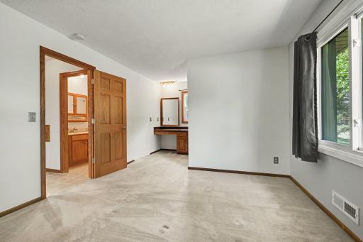 Main level bedroom with dressing area & walkin closet