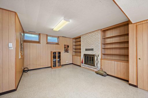 Lower level family room w built ins and wood FP and storage.