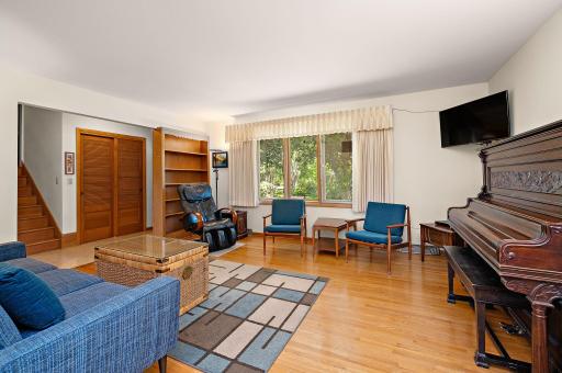 Bright and roomy living space with original hardwood floor.