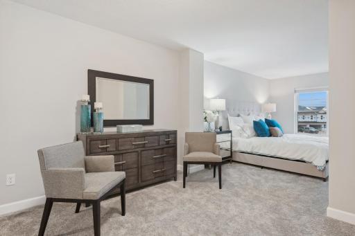 (Photo of a decorated model, actual homes finishes will vary) Another view of the primary bedroom.