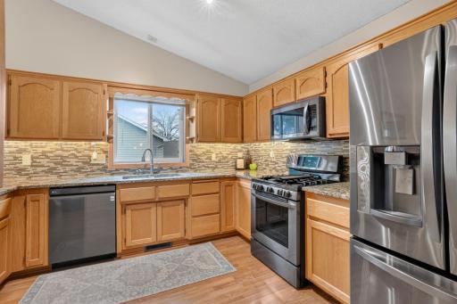 Stone countertops and stainless steel appliances combine style and functionality.