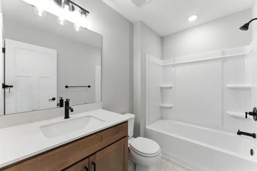 Upper level hall bath. Similar home shown, color and finish can vary.