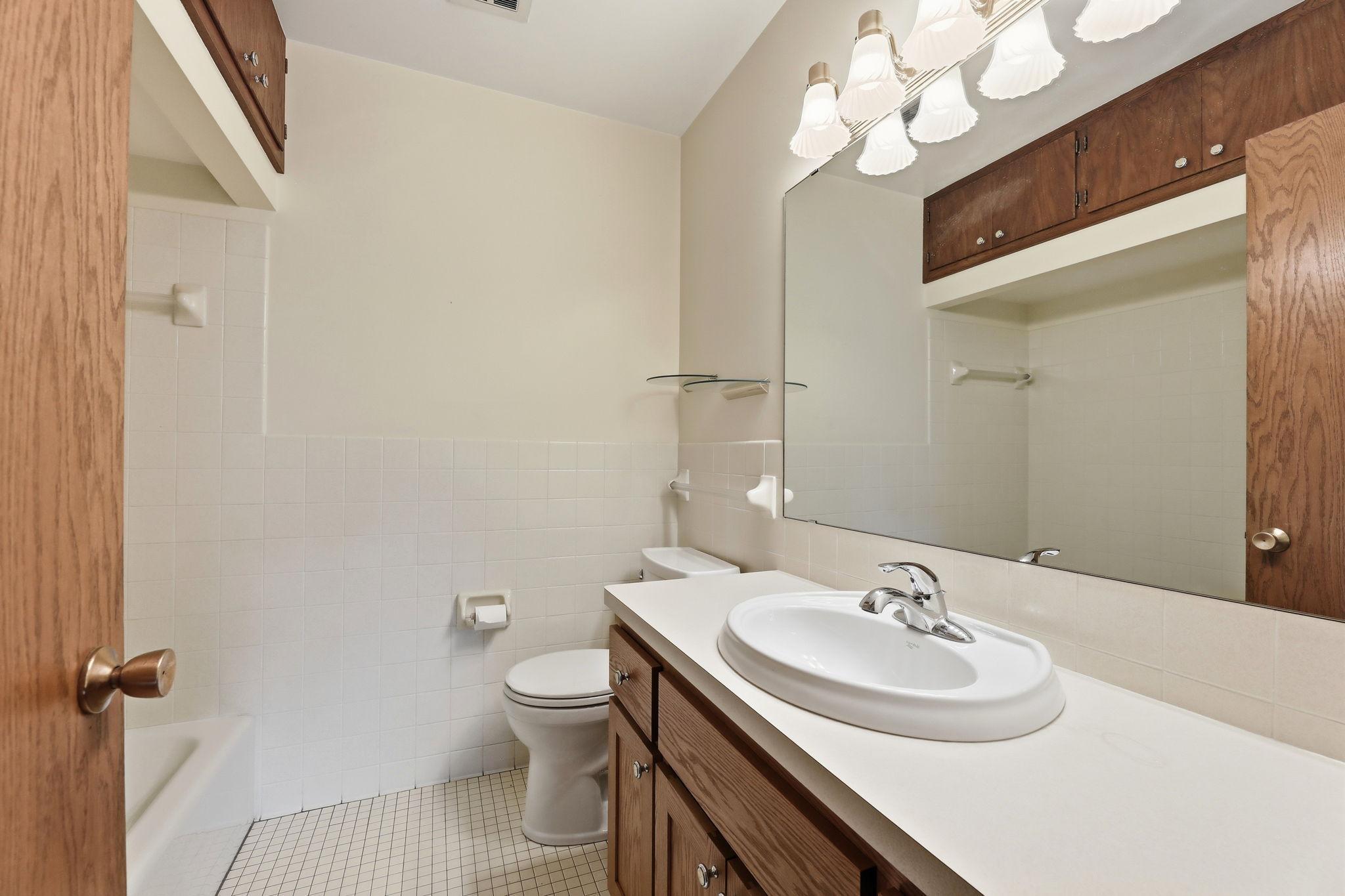 Main floor full bathroom with handy built in storage and great linen closet.