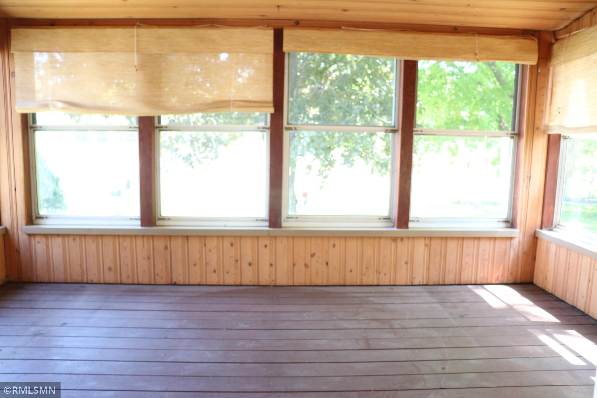 Screen porch behind garage.
