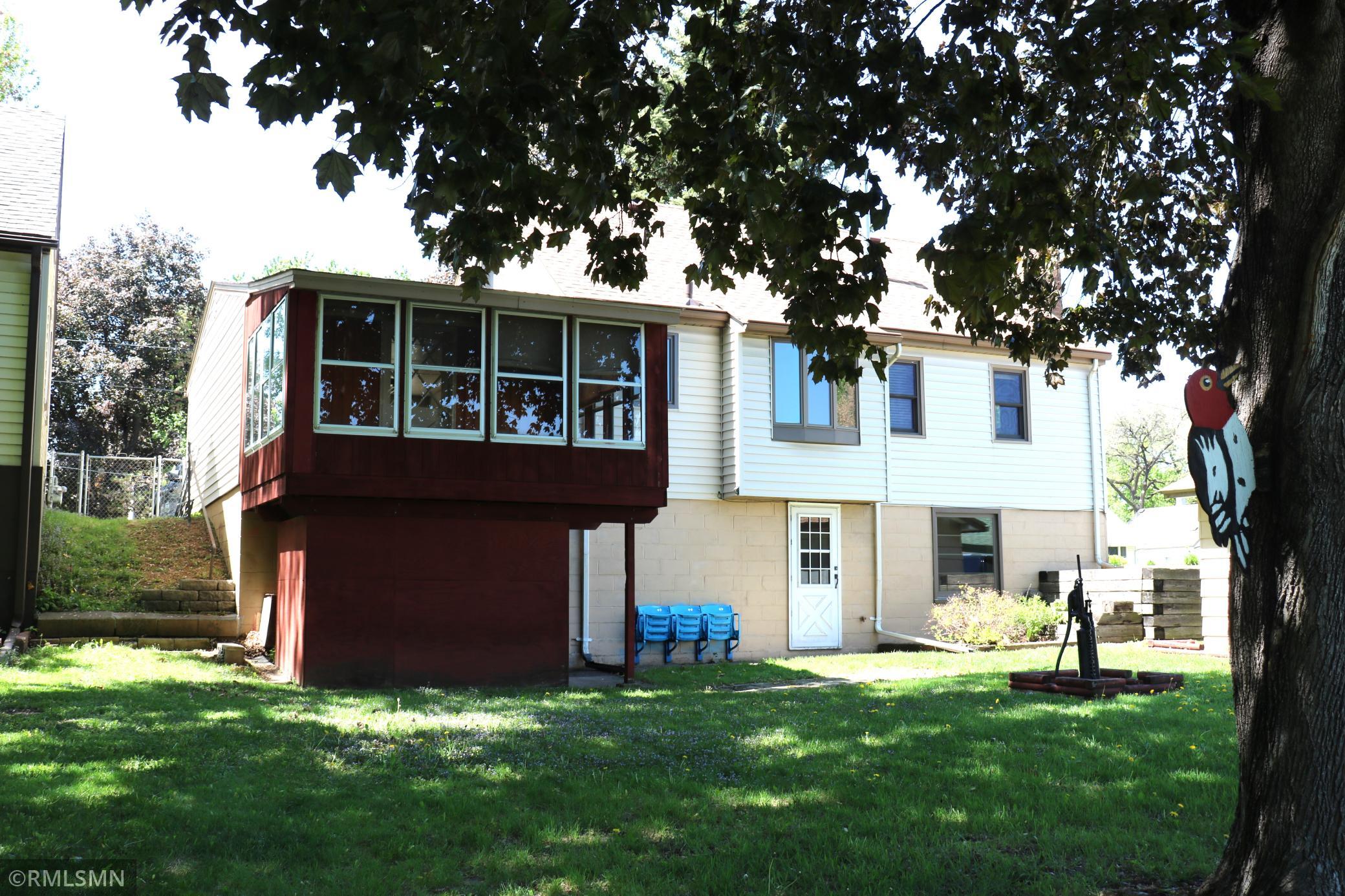 Back of home, walkout basement, screen porch and shop area.