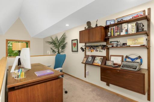 Primary ensuite loft offers flex space with access to the upper level bedrooms.