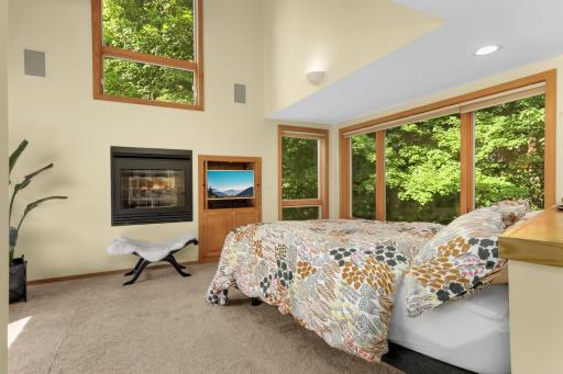 Main level primary ensuite with cozy fireplace.