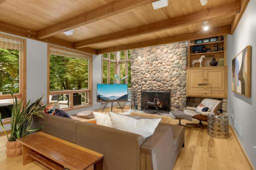 Stunning fieldstone fireplace anchors this space.