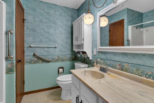 Main floor bathroom with a tub/shower and linen closet