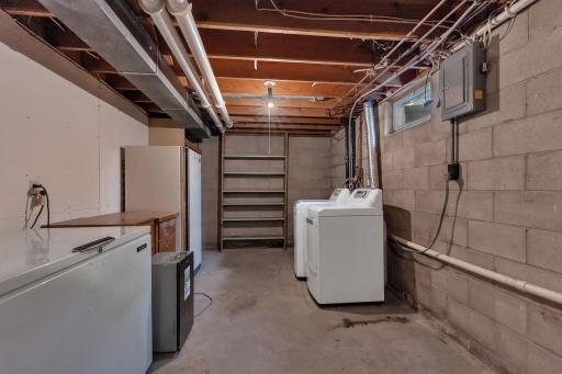 Utility room with storage shelves and laundry