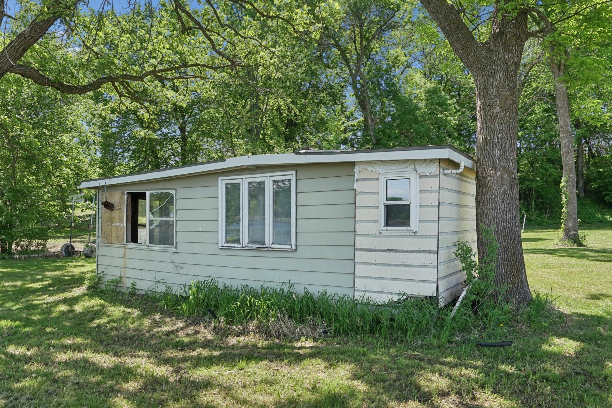 There is an old cabin, small and uninhibitable on the property.