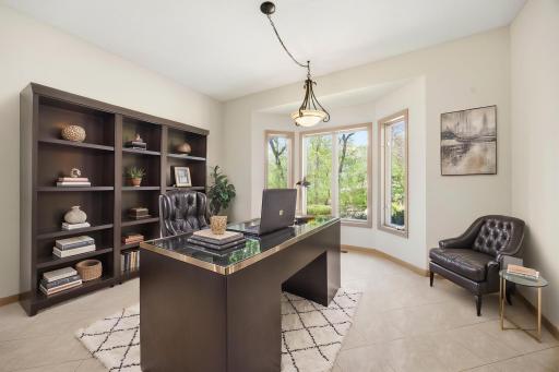 Main floor office/den. Photo is virtually staged.