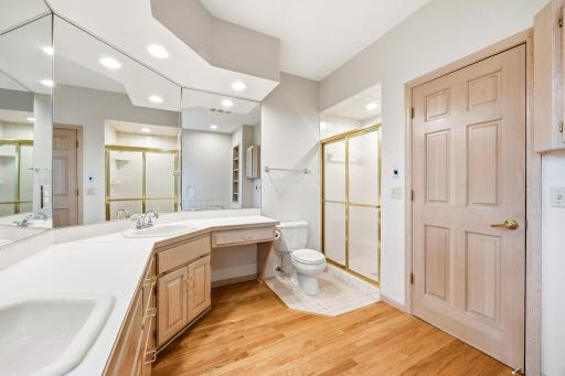 Main floor primary bathroom with dual sinks and separate tub and shower.