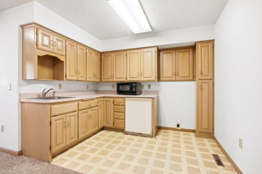 This home offers three kitchens. This kitchenette is adjacent to the 4th bedroom/bath. Its flows into the large amusement room which could make the perfect MIL apartment, or a great movie theater space.