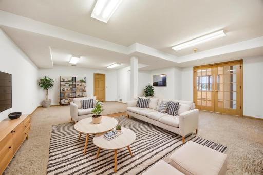 Lower level ameusement room connected to kitchenette and MIL suite. Make this an outstanding theater, game room, or a massive finished storage room. Photo is virtually staged.
