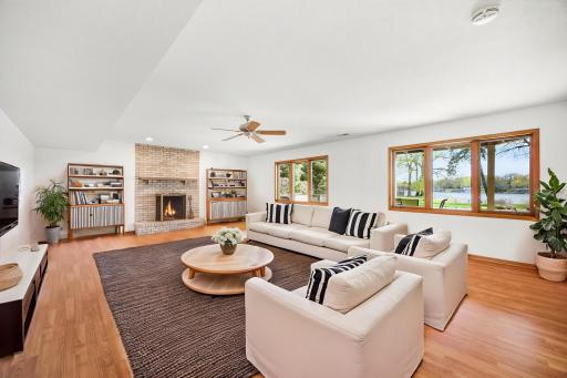 Lower level family room near the full lower level kitchen. Room features a gas fireplace and nice nature views.