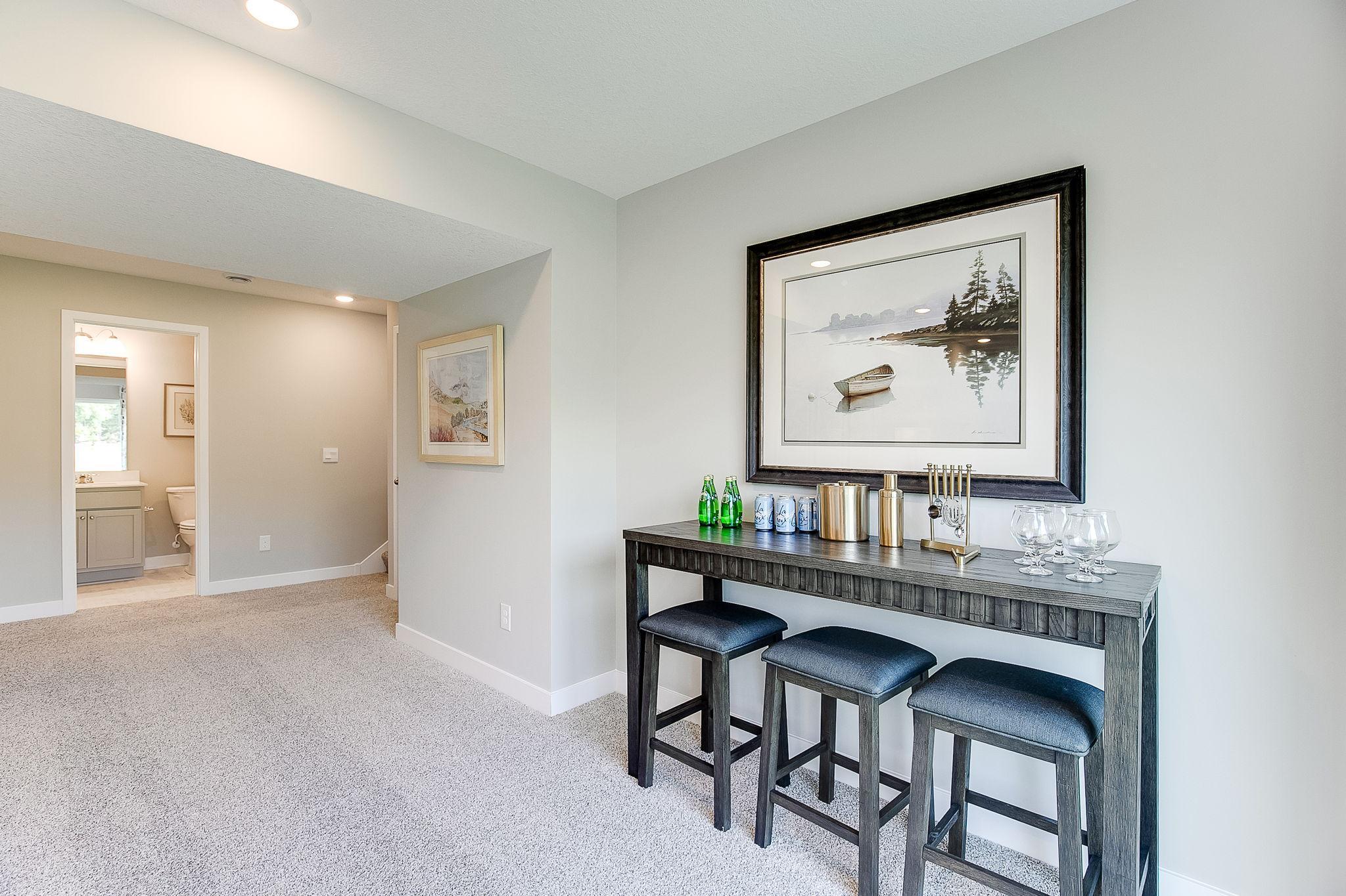 The Bryant II Lower Level Family Room at Highlands at Eagle View in Elko New Market. Photo is of similar home. Options and colors may vary. Ask Sales Agent for details.