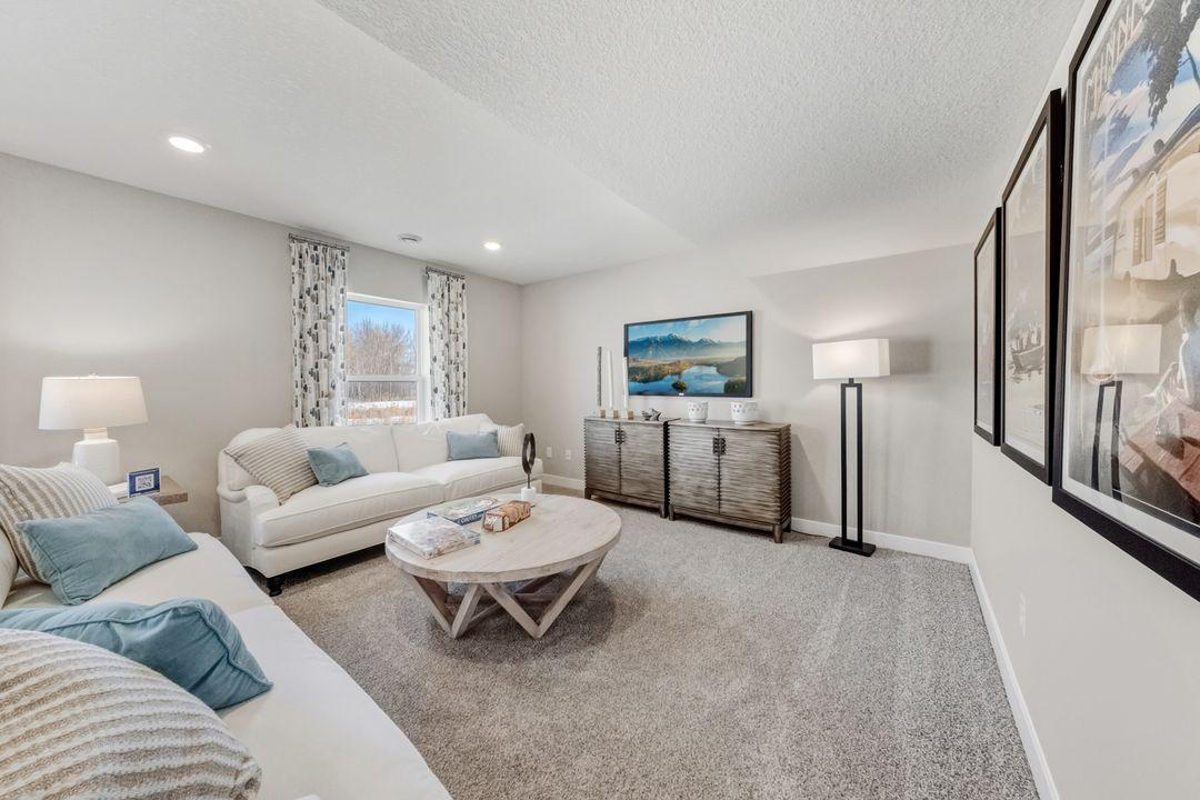 The Bryant II Lower Level Family Room at Highlands at Eagle View in Elko New Market. Photo is of similar home. Options and colors may vary. Ask Sales Agent for details.