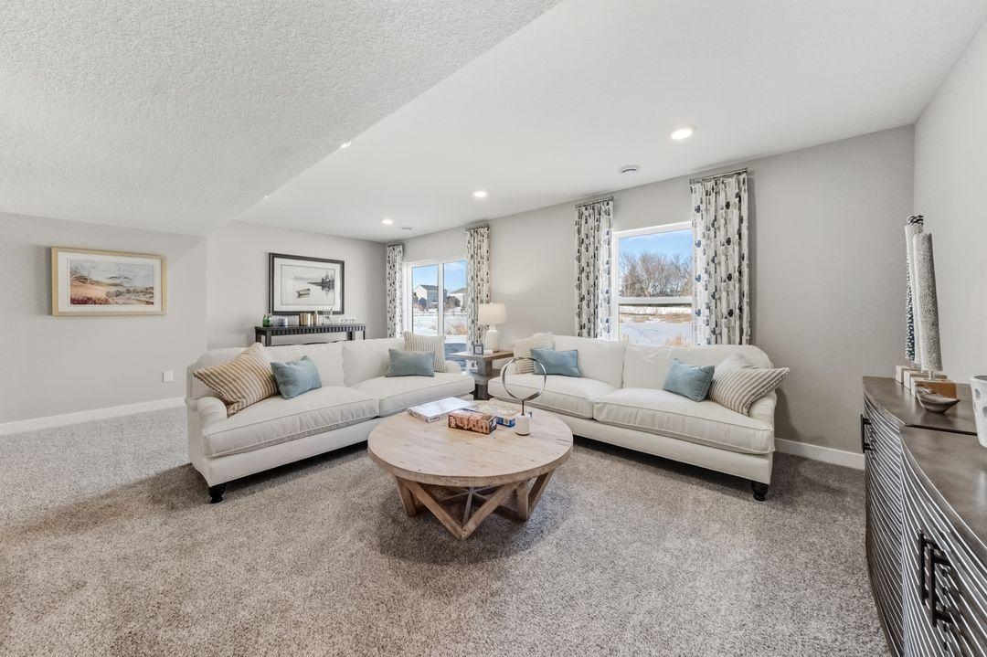 The Bryant II Lower Level Family Room at Highlands at Eagle View in Elko New Market. Photo is of similar home. Options and colors may vary. Ask Sales Agent for details.