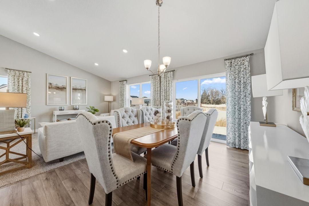 Open concept living with a modern electric fireplace. Our smart home package is included in every home. Photo is of model home. Colors and options may vary. Ask Sales Agent for details.