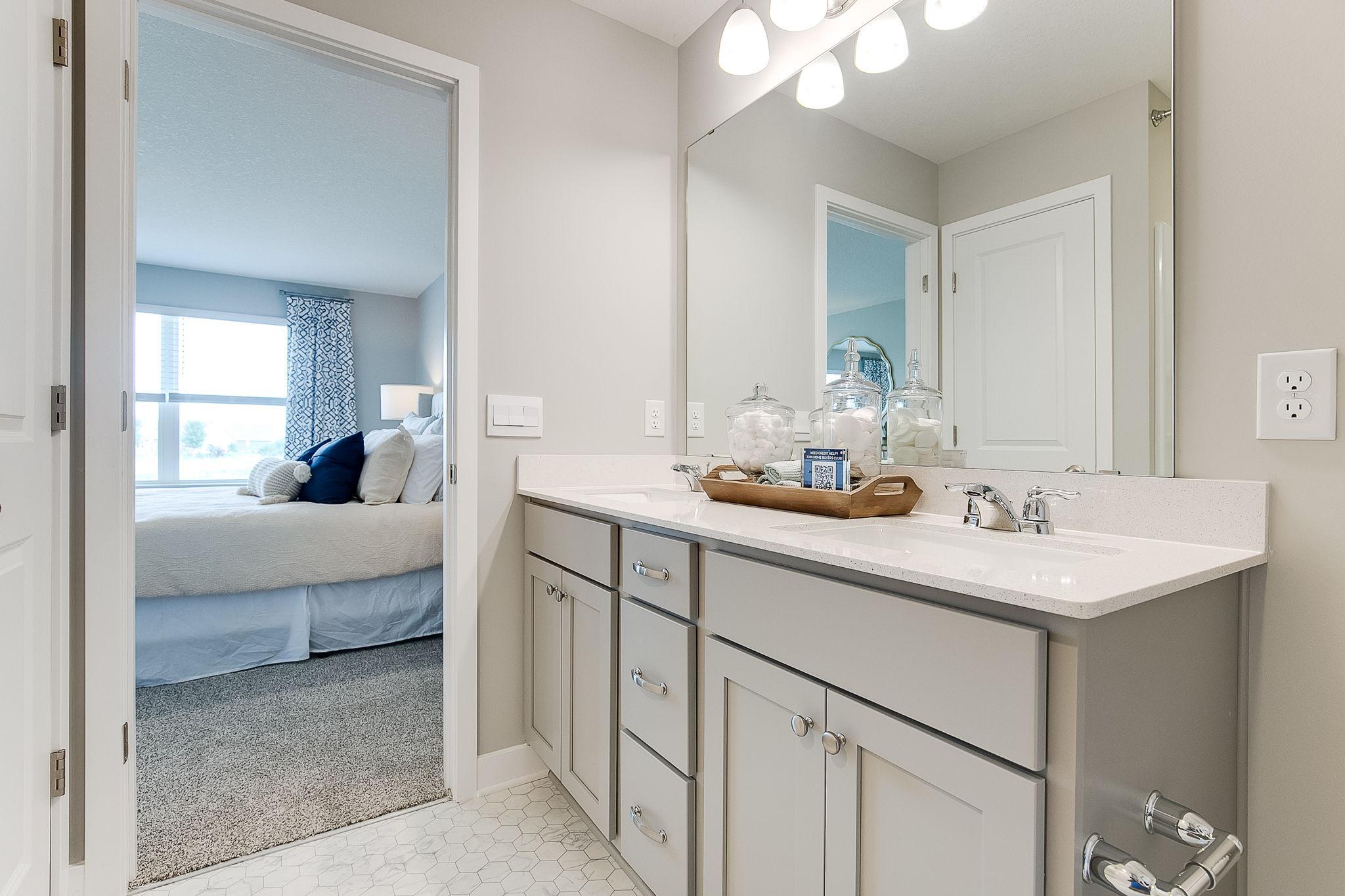 Dual sinks in primary bathroom. Photos of model home. Colors and options may vary. Ask Sales Agent for details.