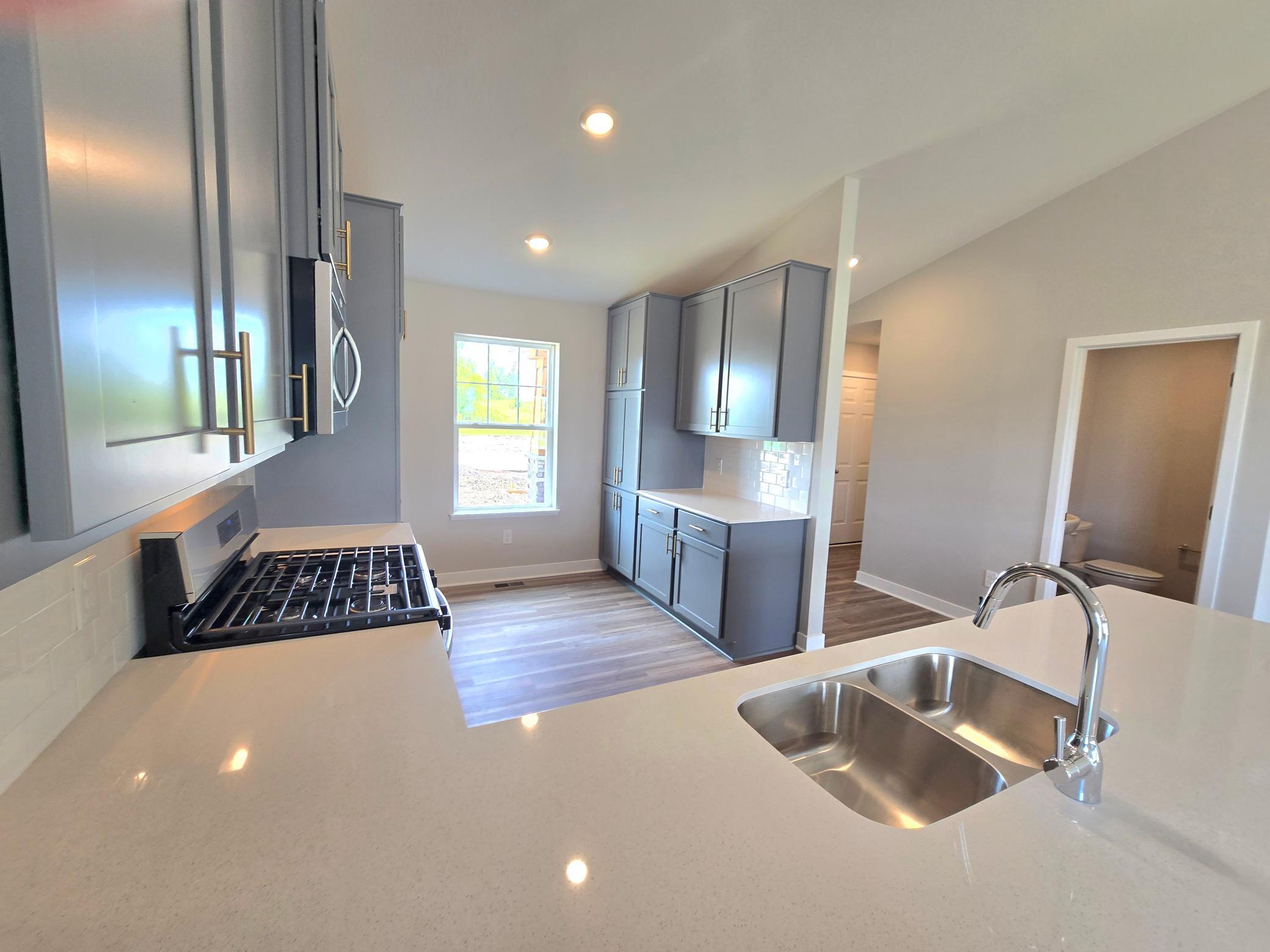 The Bryant II Kitchen shown with Harbor Gray cabinets at Highlands at Eagle View in Elko New Market. Photo is of actual home. Options and colors may vary. Ask Sales Agent for details.