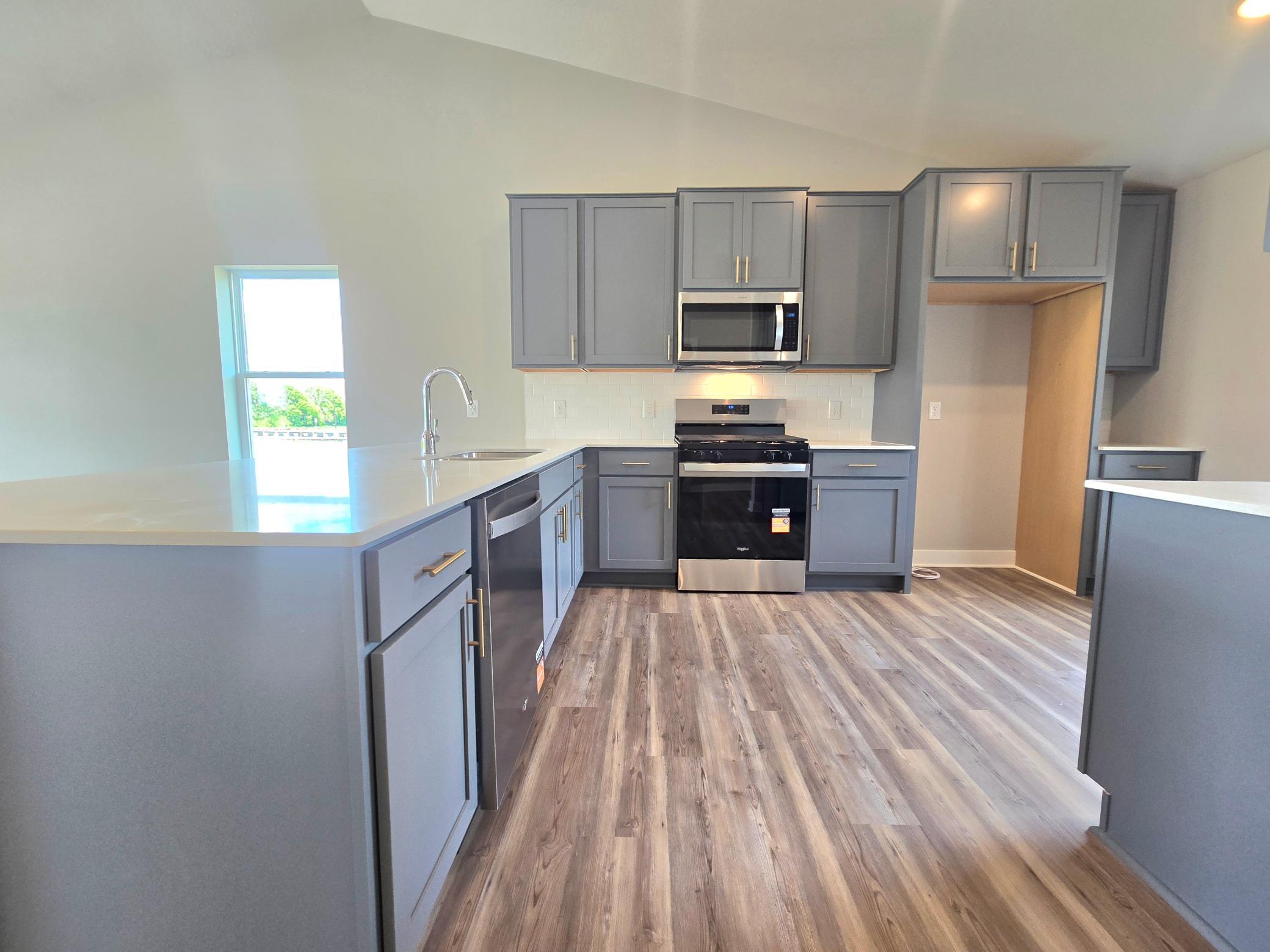 The Bryant II Kitchen shown with Harbor Gray cabinets at Highlands at Eagle View in Elko New Market. Photo is of actual home. Options and colors may vary. Ask Sales Agent for details.