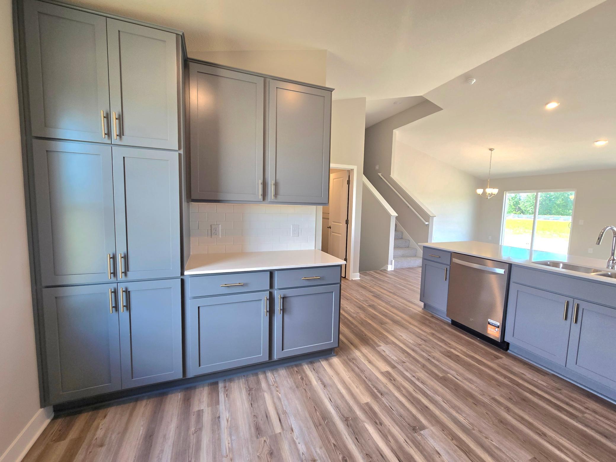 The Bryant II Kitchen shown with Harbor Gray cabinets at Highlands at Eagle View in Elko New Market. Photo is of actual home. Options and colors may vary. Ask Sales Agent for details.