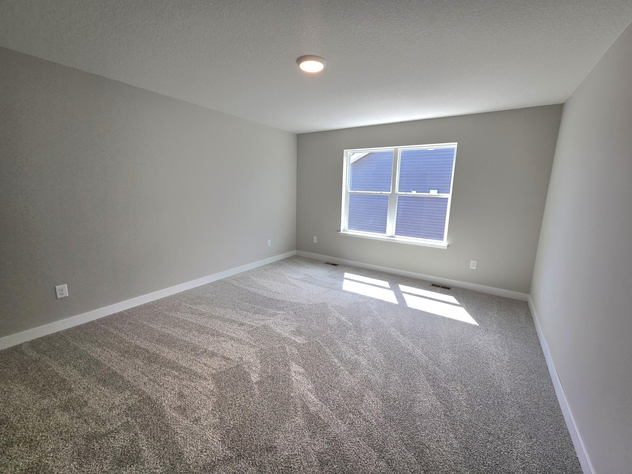 The Bryant II Primary Bedroom at Highlands at Eagle View in Elko New Market. Photo is of actual home. Options and colors may vary. Ask Sales Agent for details.