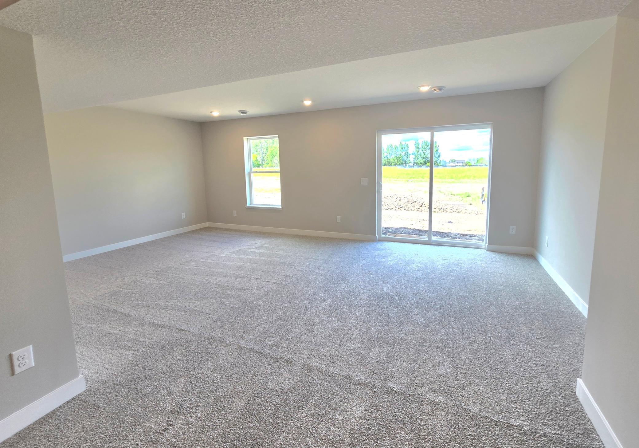 The Bryant II Lower Level Family Room at Highlands at Eagle View in Elko New Market. Photo is of actual home. Options and colors may vary. Ask Sales Agent for details.
