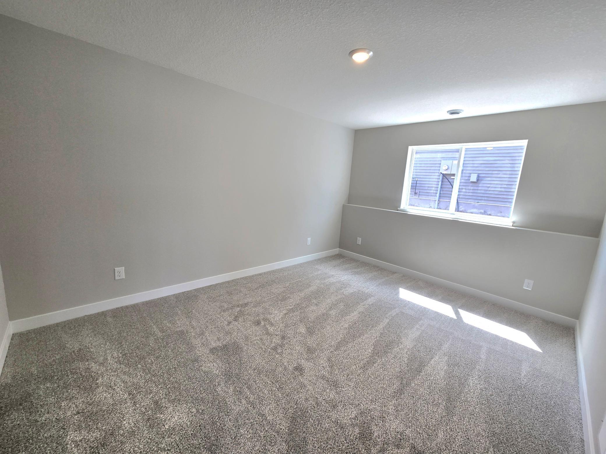 The Bryant II Lower Level Bedroom at Highlands at Eagle View in Elko New Market. Photo is of actual home. Options and colors may vary. Ask Sales Agent for details.