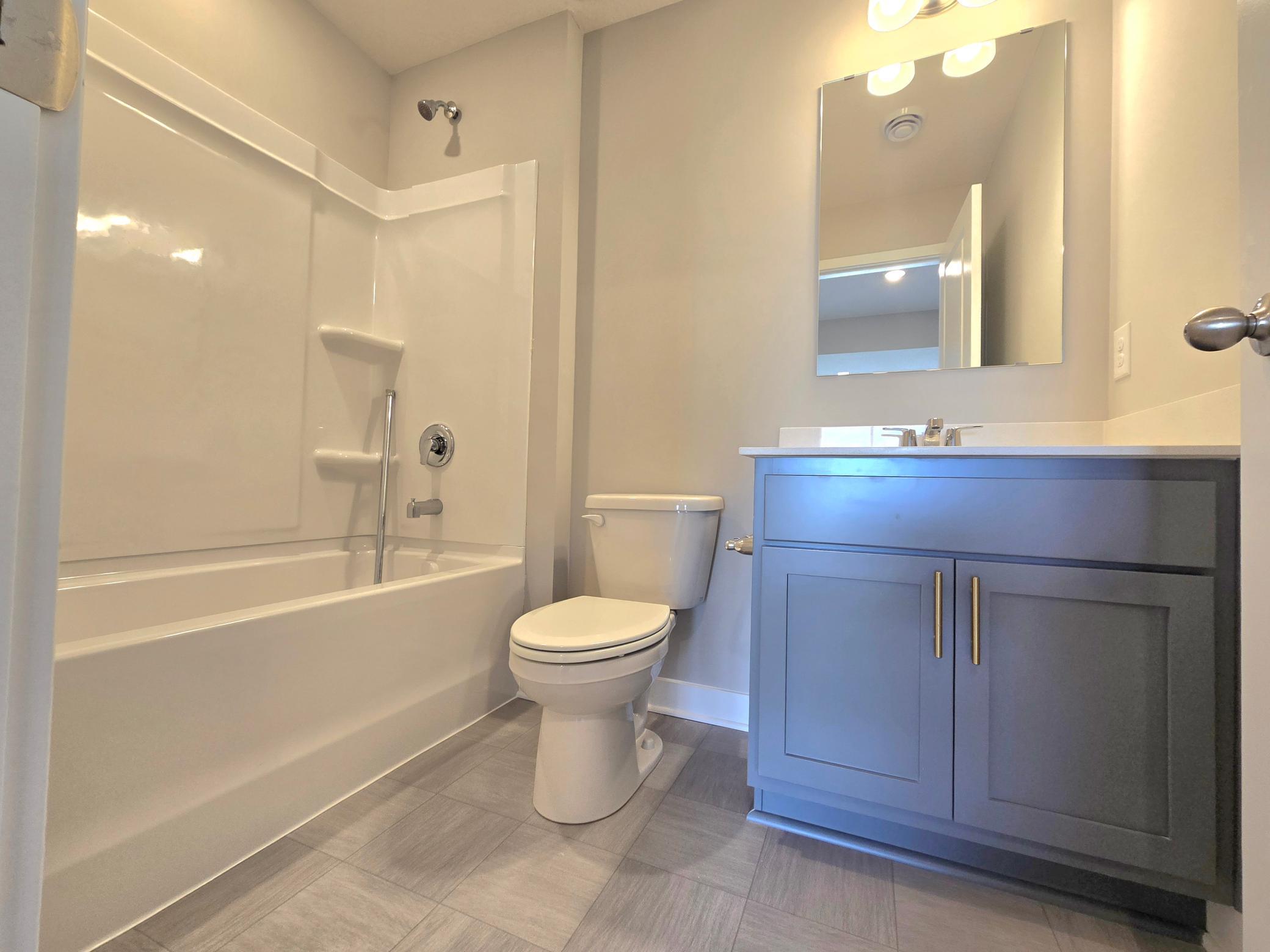The Bryant II Lower Level Bathroom shown with Harbor Gray cabinets at Highlands at Eagle View in Elko New Market. Photo is of actual home. Options and colors may vary. Ask Sales Agent for details.