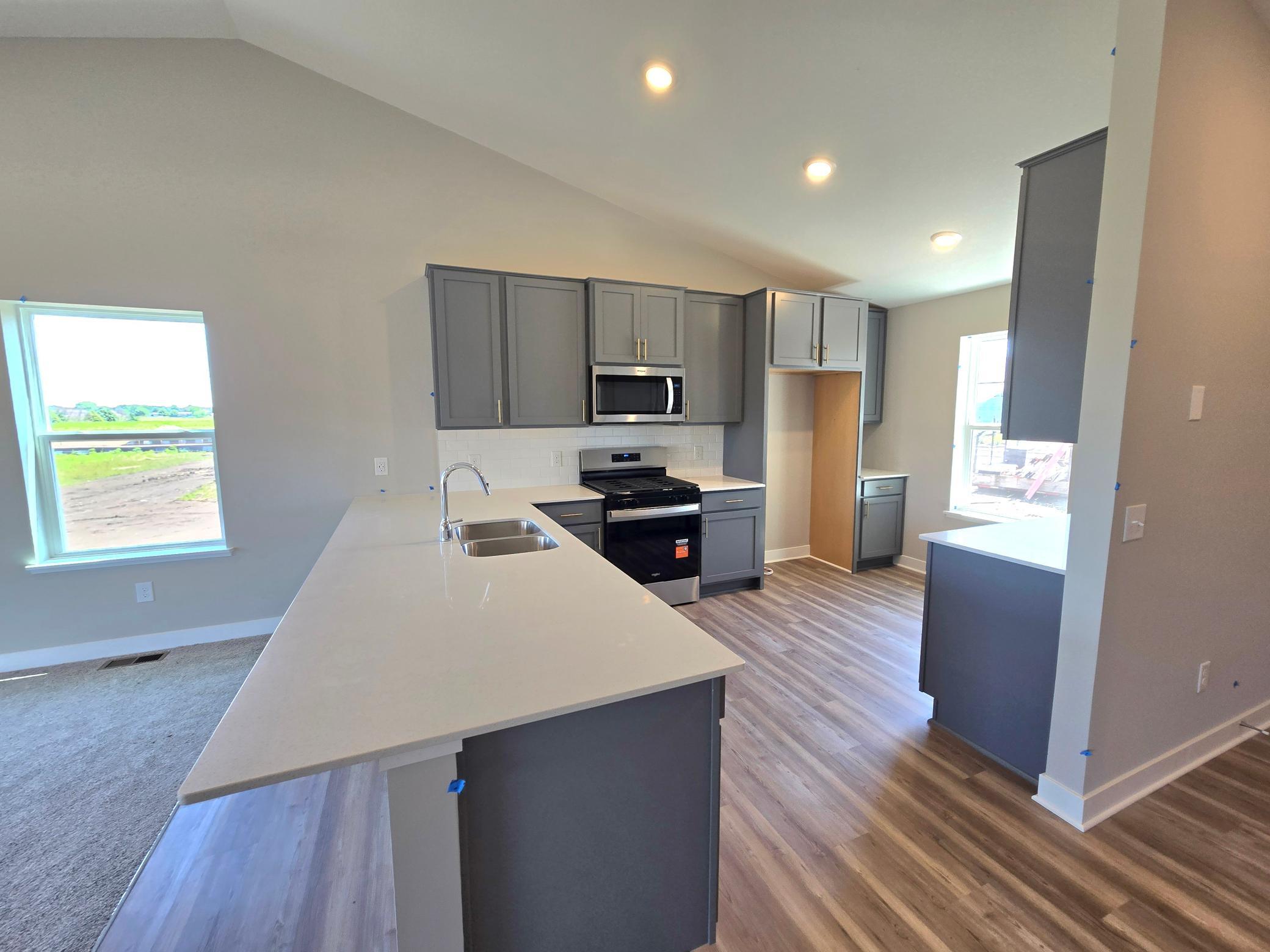 The Bryant II Kitchen shown with Harbor Gray cabinets at Highlands at Eagle View in Elko New Market. Photo is of actual home. Options and colors may vary. Ask Sales Agent for details.