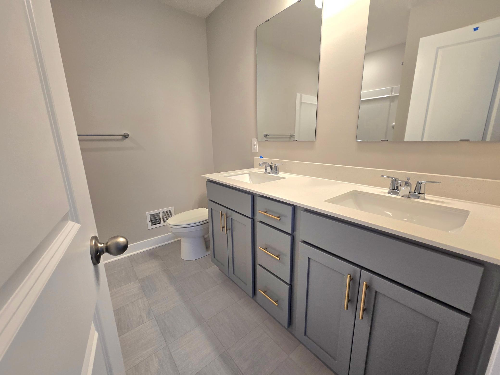 The Bryant II Primary Bathroom shown with Harbor Gray cabinets at Highlands at Eagle View in Elko New Market. Photo is of actual home. Options and colors may vary. Ask Sales Agent for details.