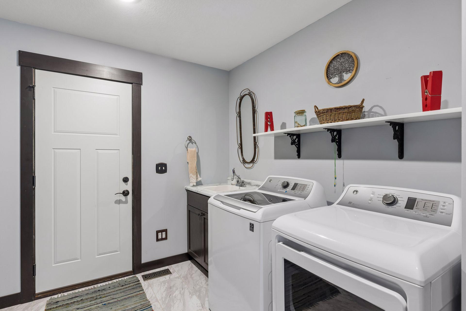 Sizable laundry room with sink and storage