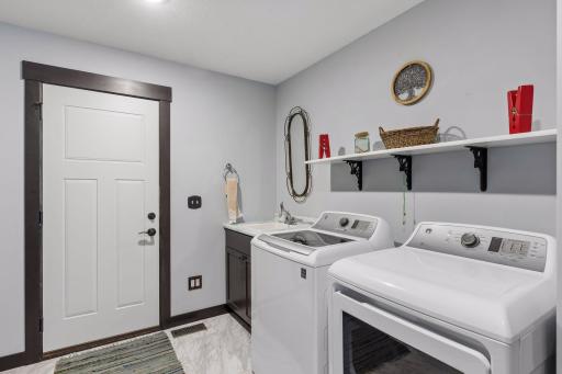 Sizable laundry room with sink and storage
