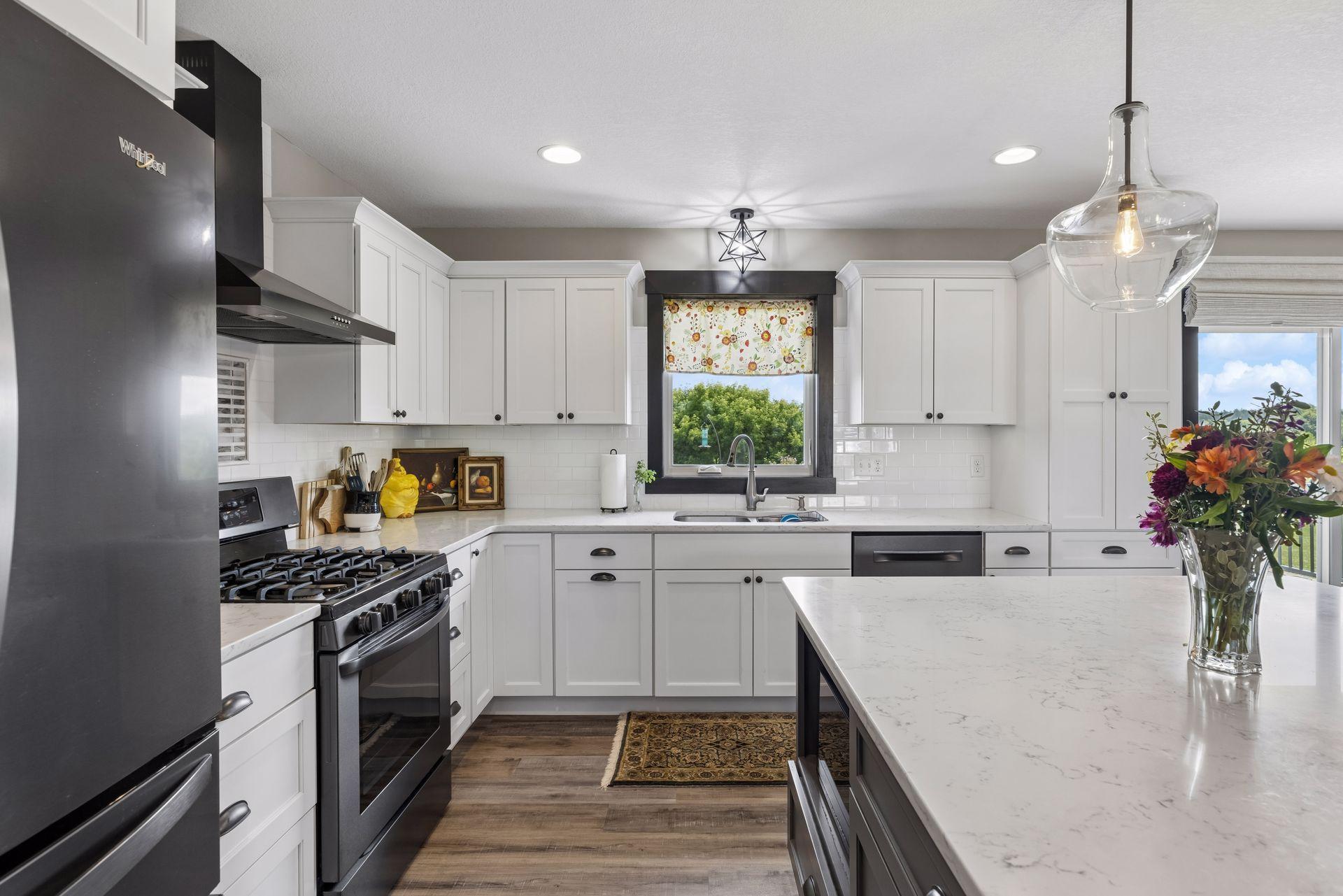 Stainless steel appliances and decorative tile backsplash