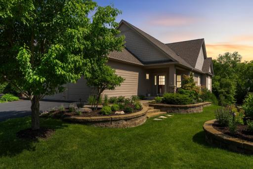 Thoughtfully designed landscape beds, manicured lawns, and established shade trees enhance the home's picturesque setting while providing privacy and charm.