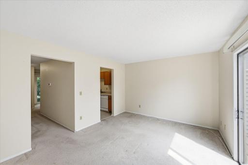 Living room looking at kitchen and hallway.