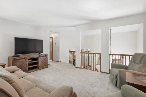 The formal living room overlooks the main level kitchen and dining room areas of the home.