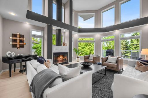Living room / Great room with gas fireplace, sweeping views of trees and the lake