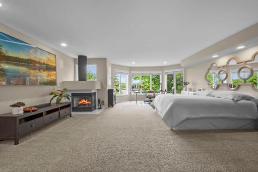Windows, fireplace, expansive primary bedroom