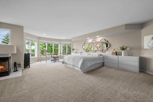 Primary bedroom suite has lake and treetop views