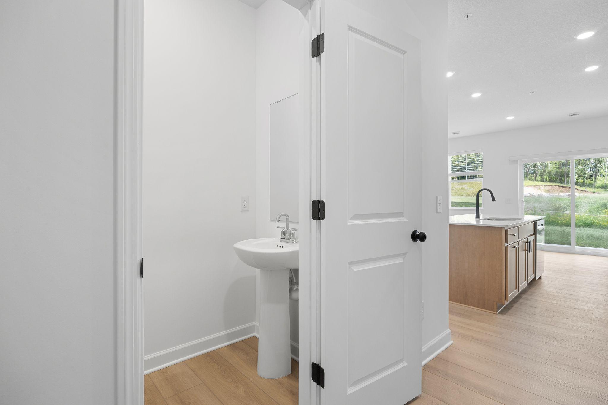 Situated directly off the kitchen, this powder room optimizes the first-floor main living area for residents and guests alike.