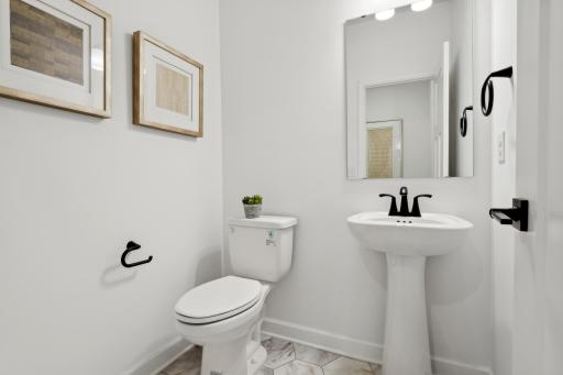 (Photo of a decorated model, actual homes finishes will vary) Main level powder bath.