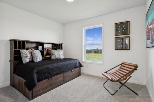 (Photo of a decorated model, actual homes finishes will vary) The third generously sized upper level secondary bedroom with a spacious closet.