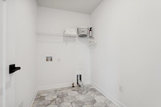 (Photo of a decorated model, actual homes finishes will vary) Upper level laundry!